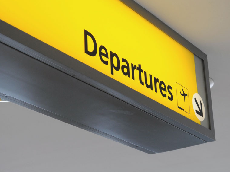 a departures sign at a airport provided by Addison Lee