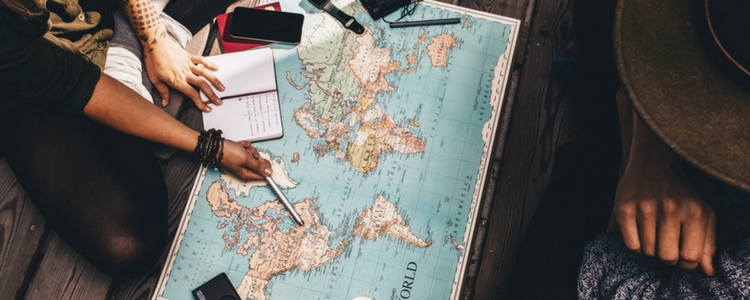 Traveller looking at the world map provided by Addison Lee car hire.