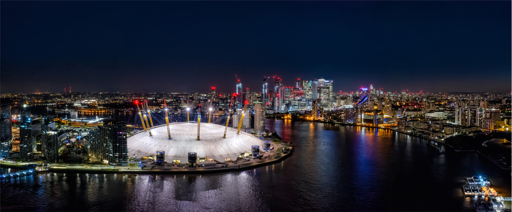 Skyline of London at night with view of O2 arena