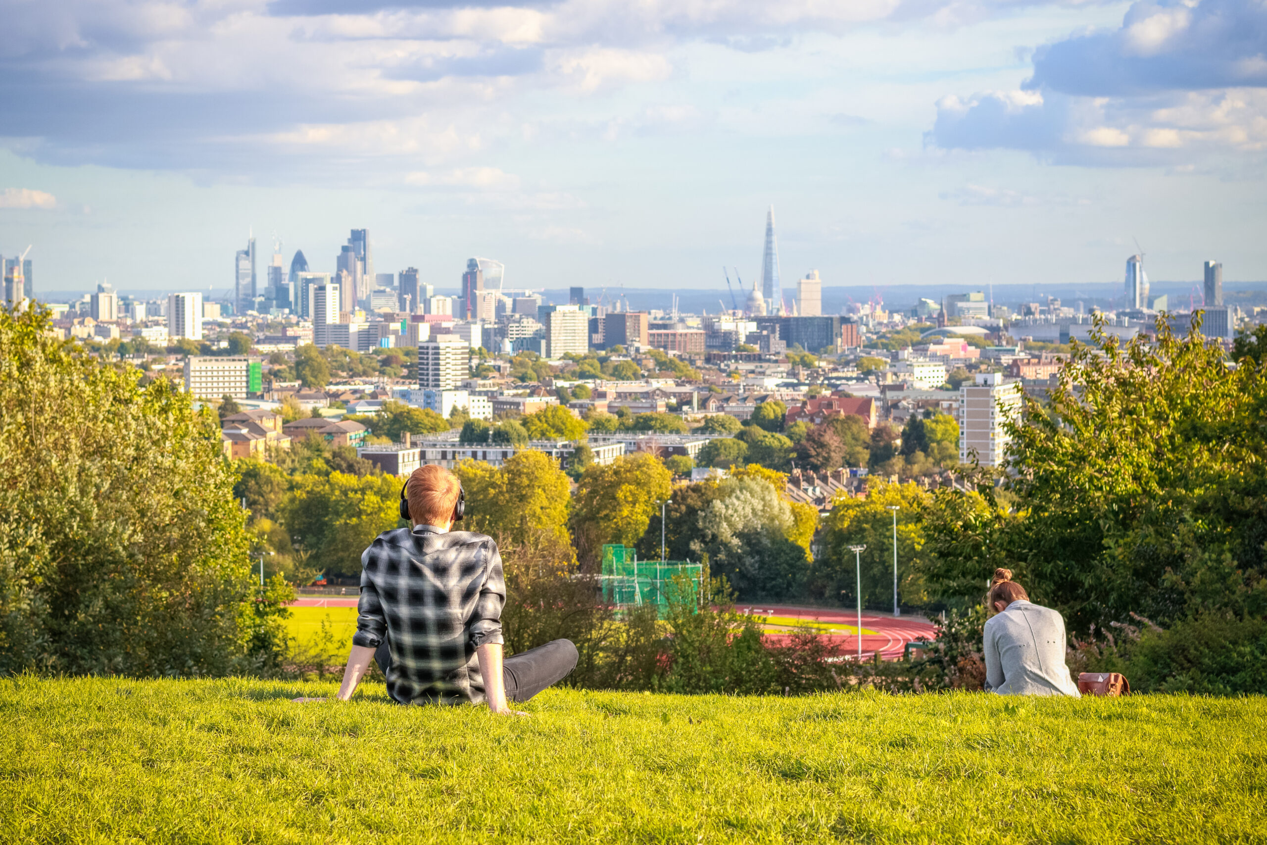 Man looking out on London skyline at Primrose Hill