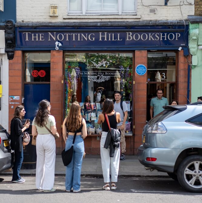 People standing outside the notting hill bookshop on a sunny day in London