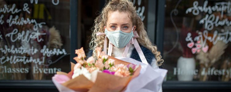 Picture of a woman beign given flowers in London provided by Addison Lee