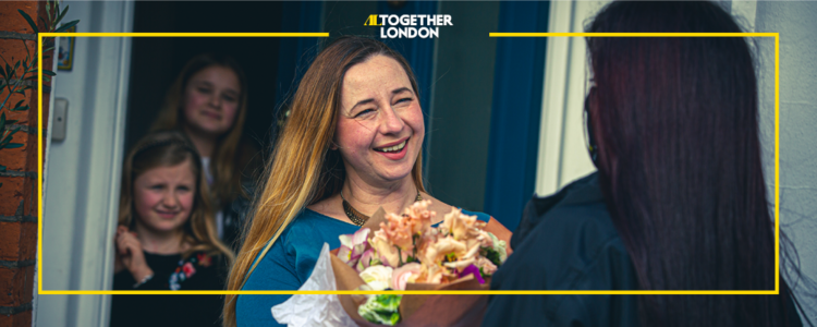 Picture of a woman beign given flowers in London provided by Addison Lee