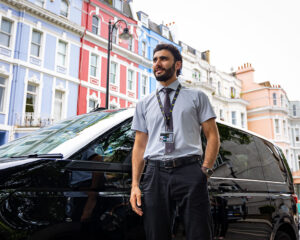 Chauffeur With Land Yard in Front of Car