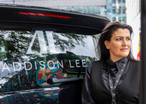 Female Chauffeur Next To AL Logo