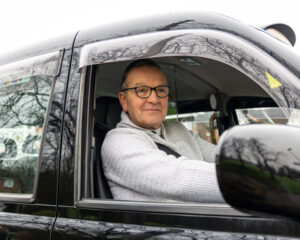 driver in black taxi