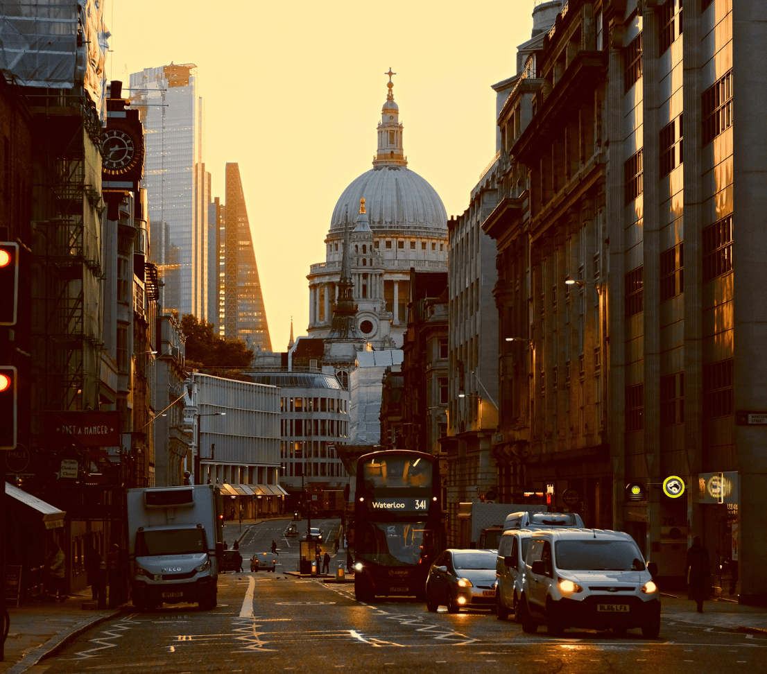 skyline of London with st paul's cathedral and traffic at sunset