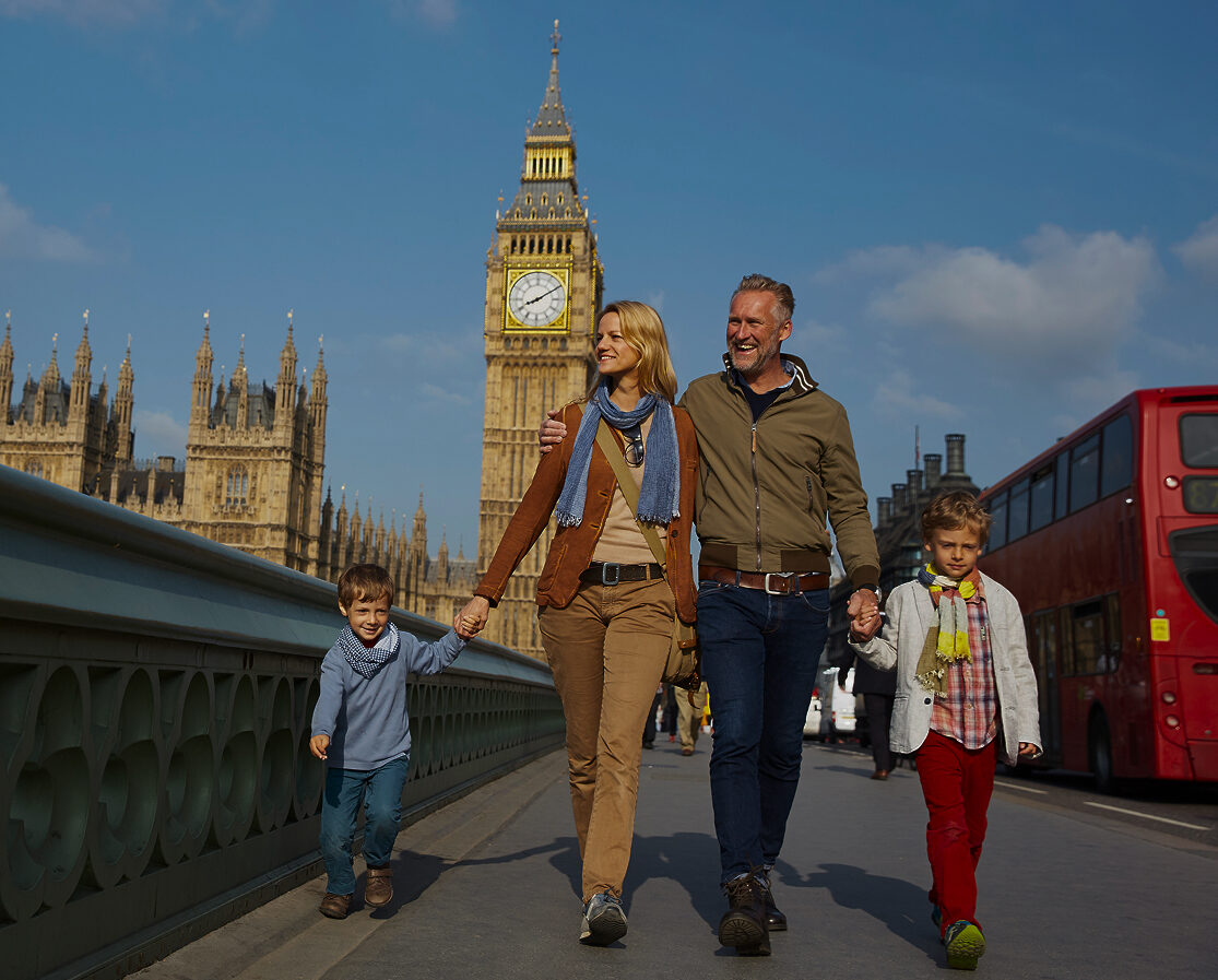 family walking through central London with big Ben in the background