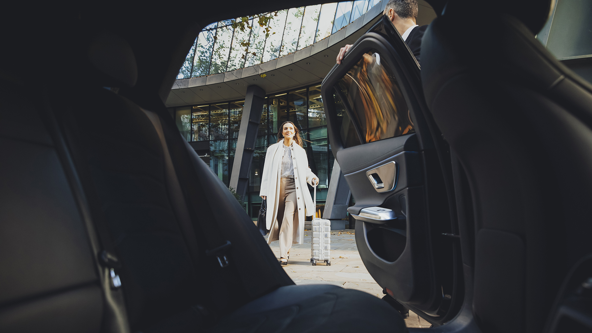Woman walking with a suitcase on her way to an Addison Lee airport transfer