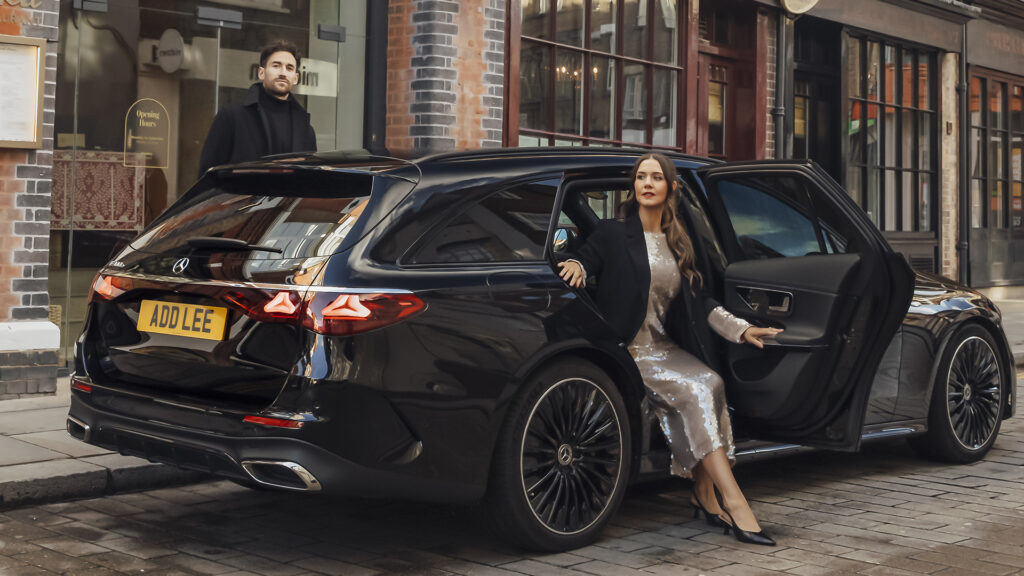 Woman walking out of an Addison Lee executive taxi
