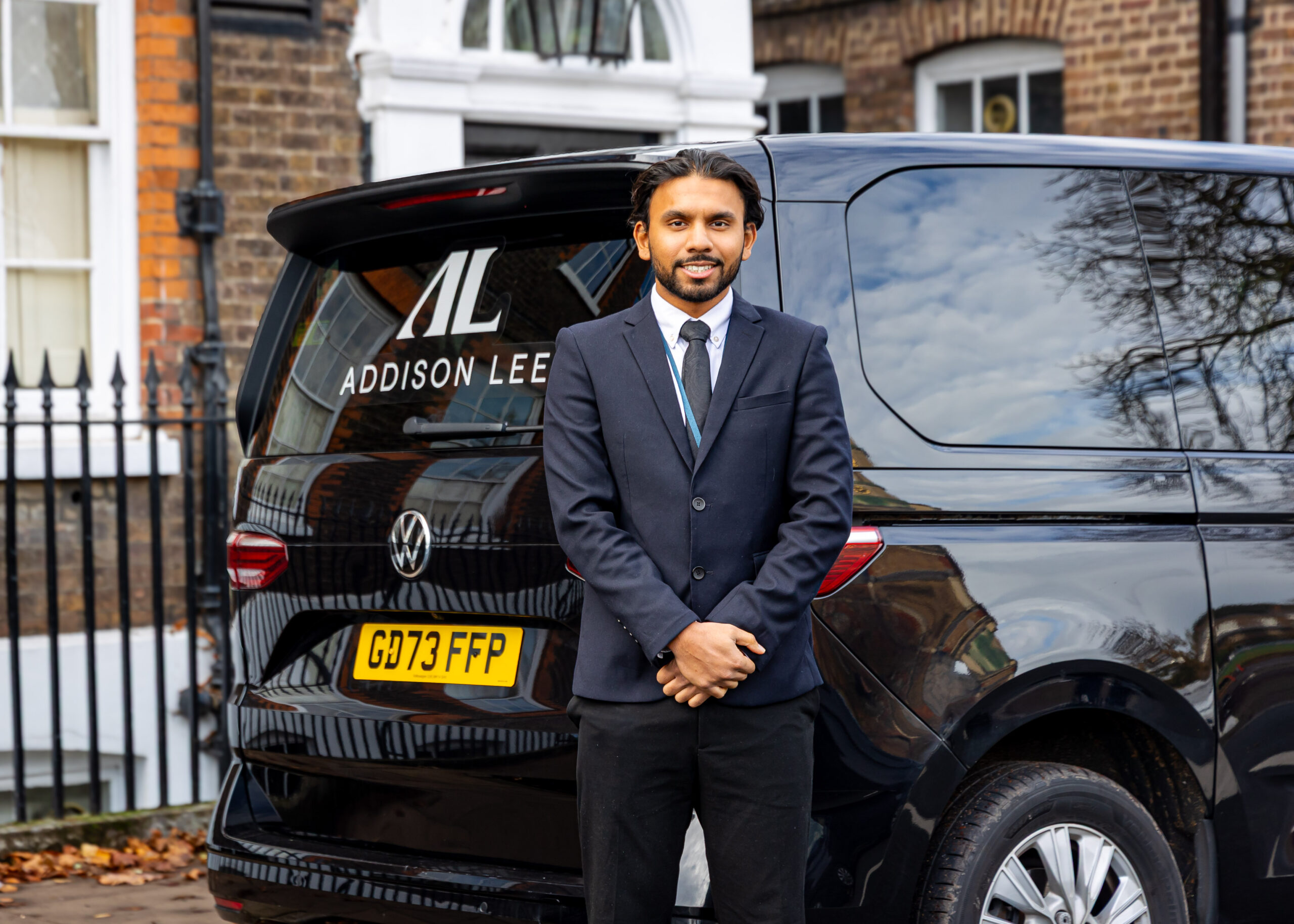 Private Hire Driver standing in front of Addison Lee MultiVan
