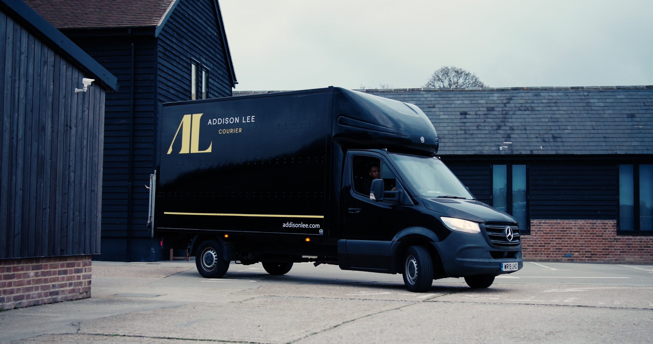Addison Lee Luton van pulling into a business park