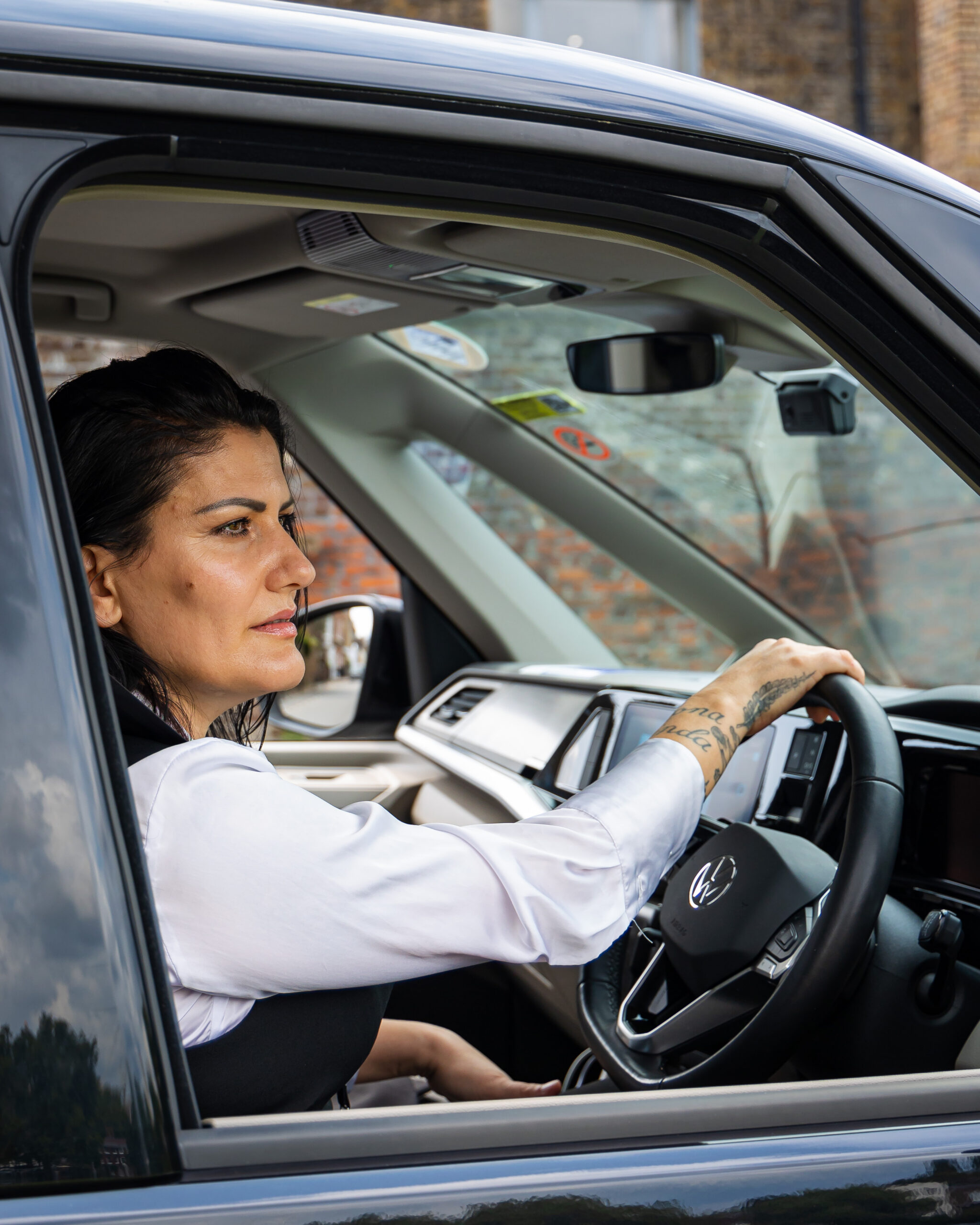 Addison Lee female driver, driving a multivan