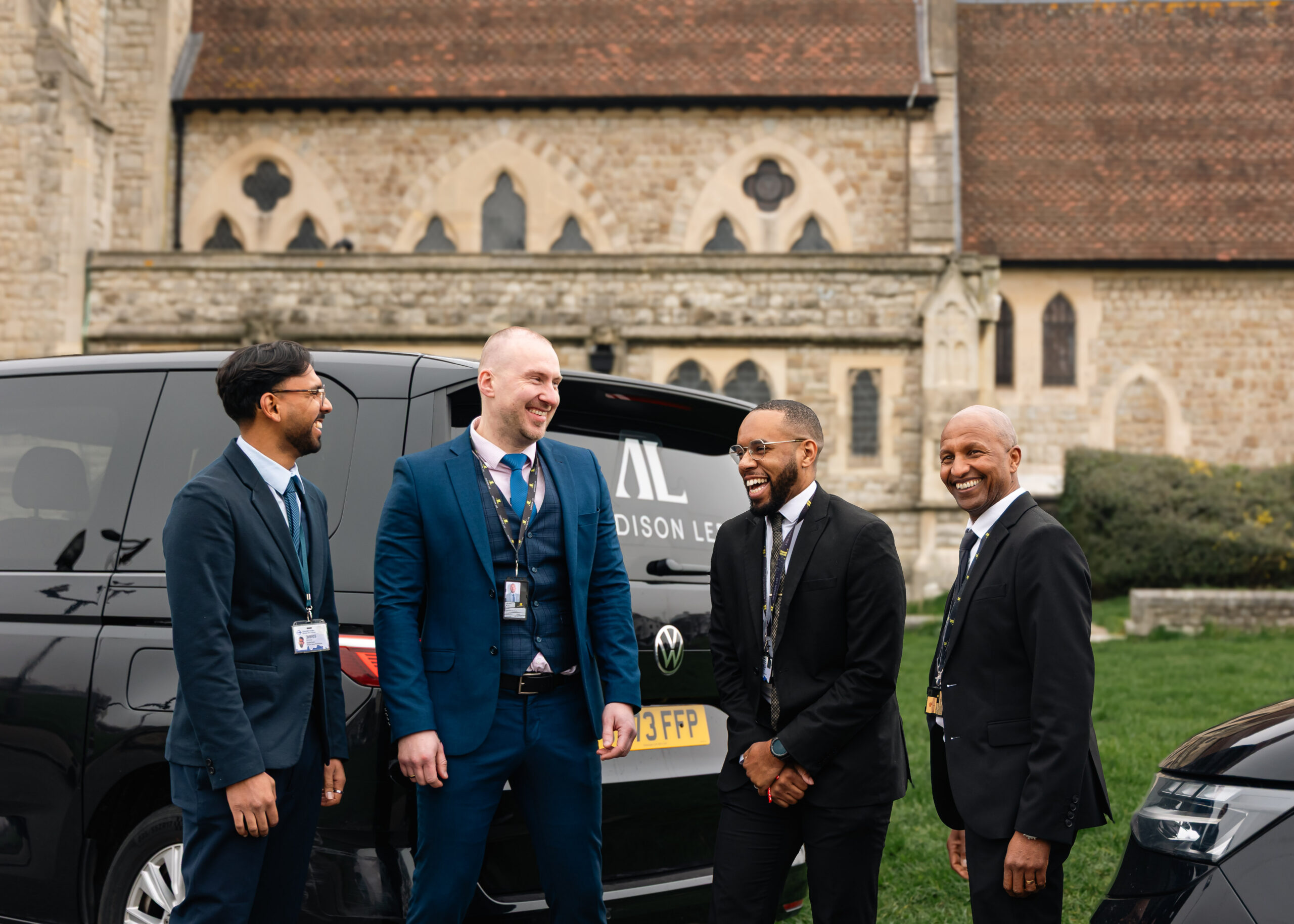 four addison lee drivers standing outside church
