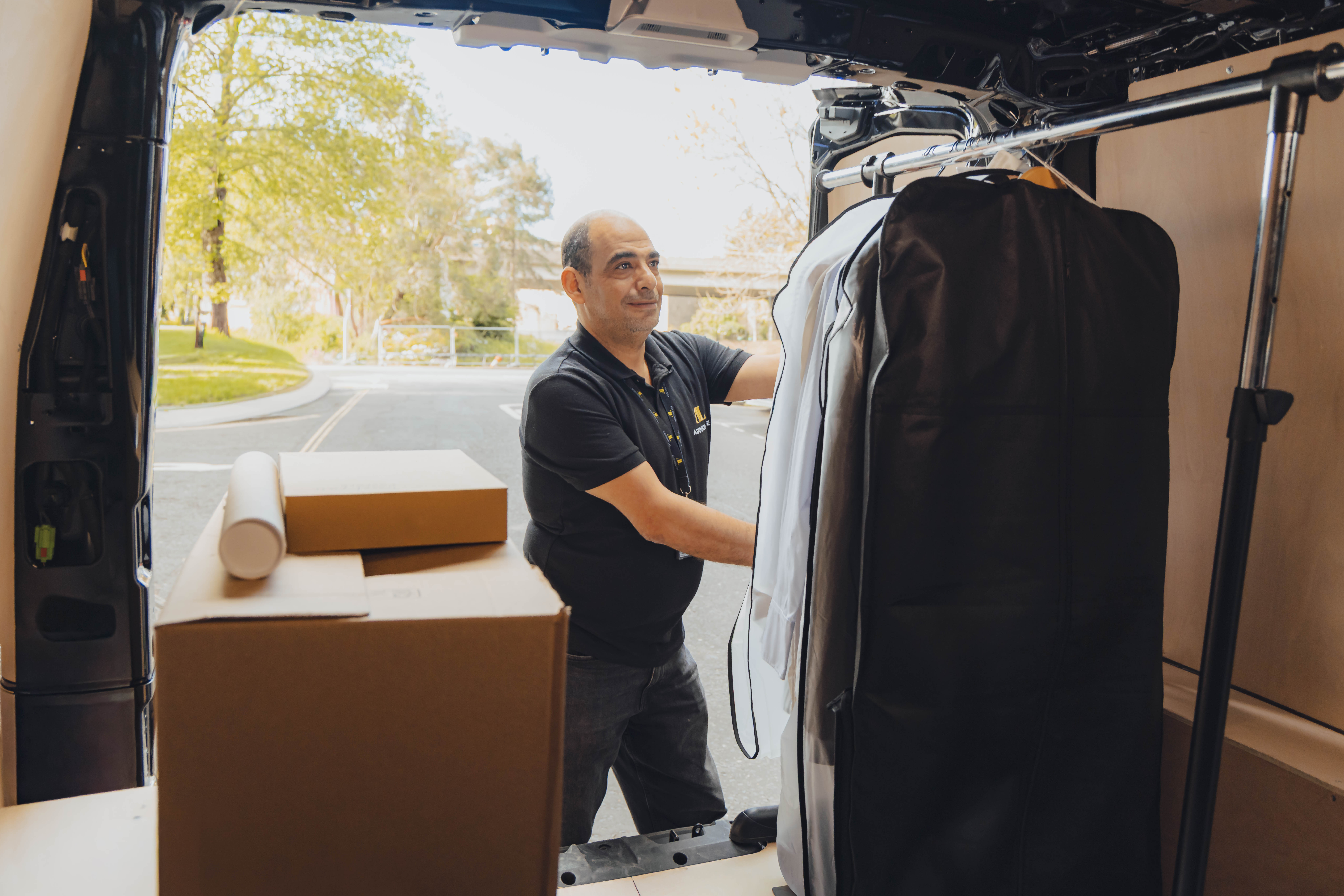 Addison Lee courier driver delivering a clothes rack to a production shoot