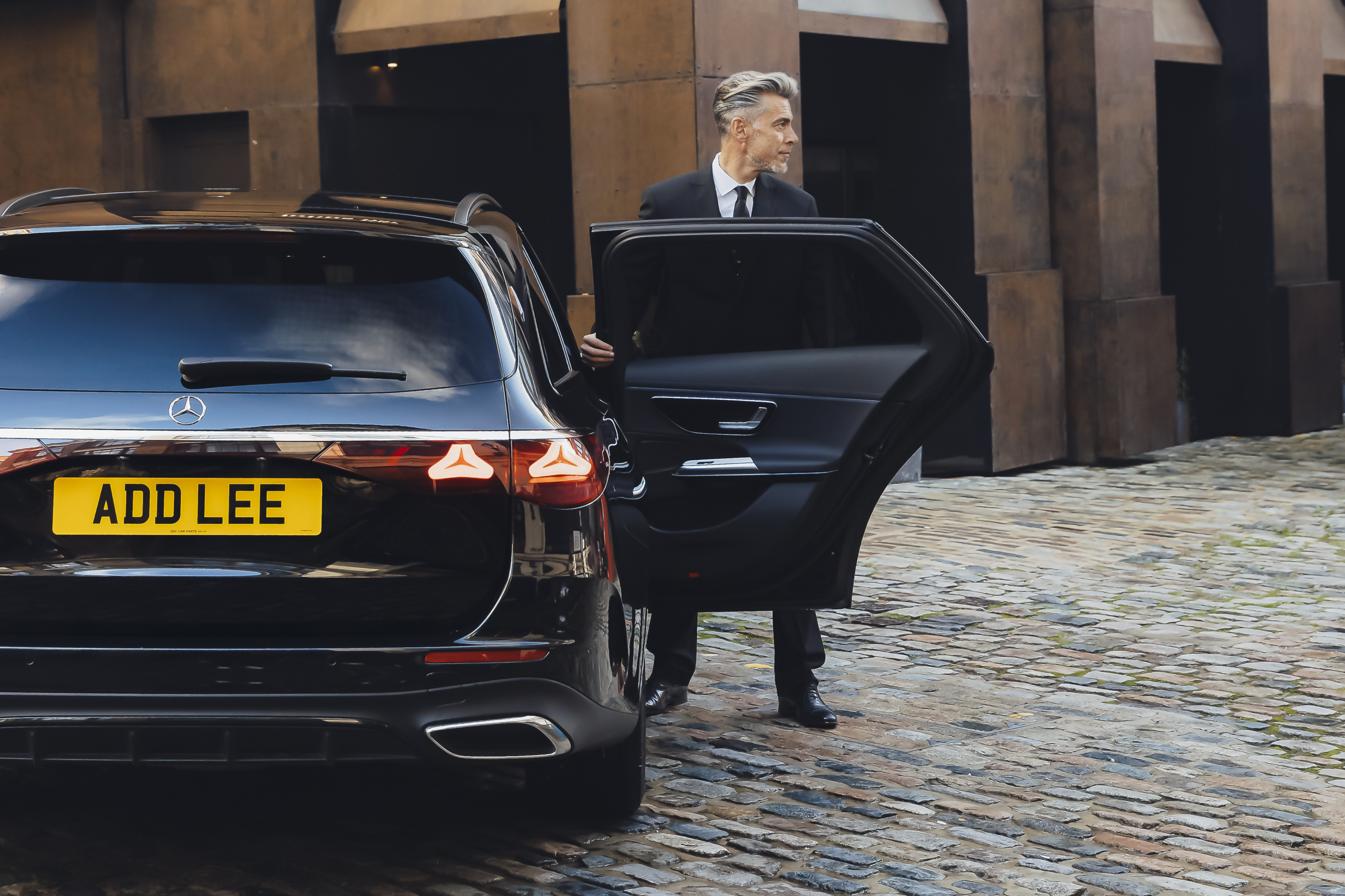 Chauffeur holding a car door open