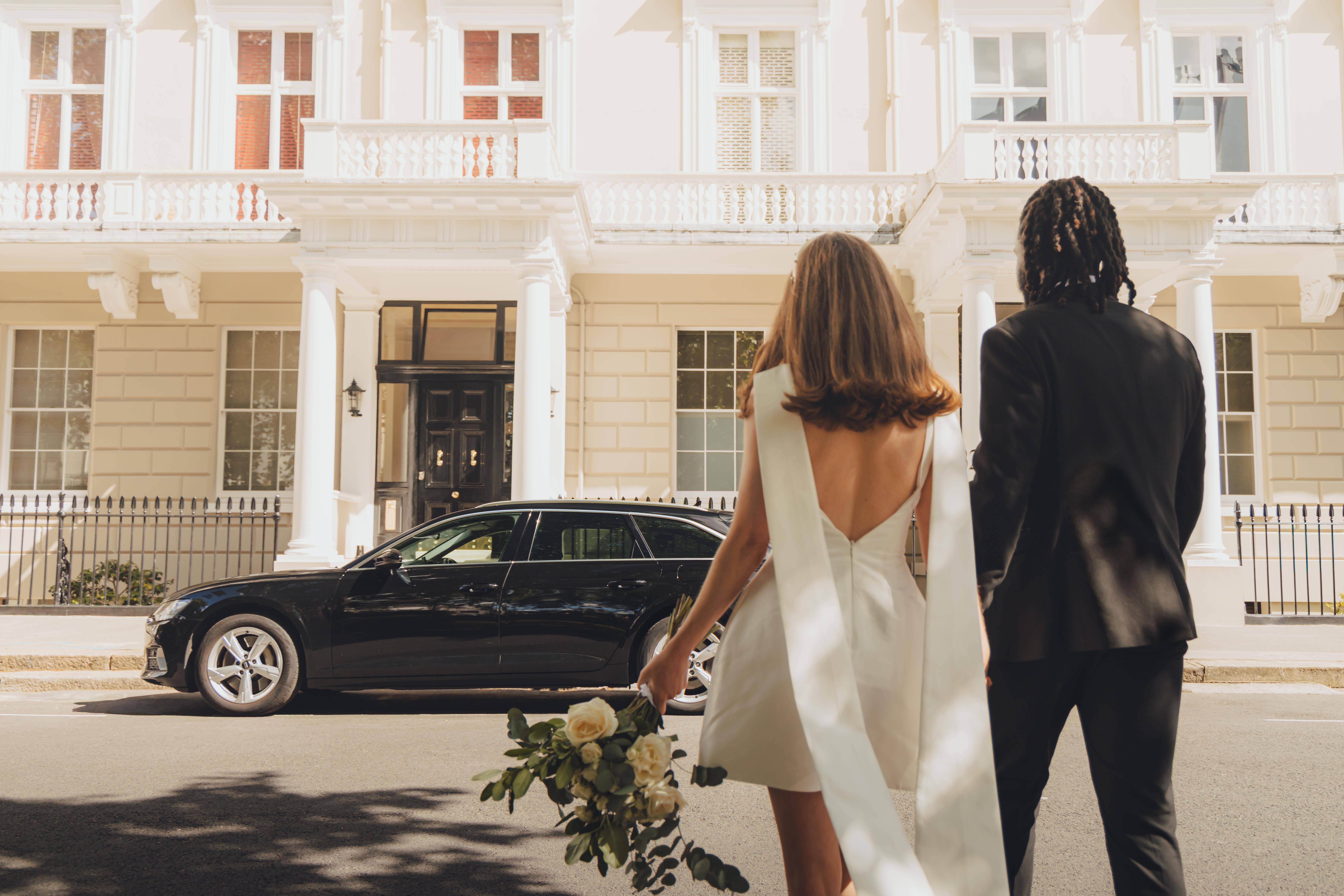 addison lee driver and executive vehicle with bride and groom walking towards car