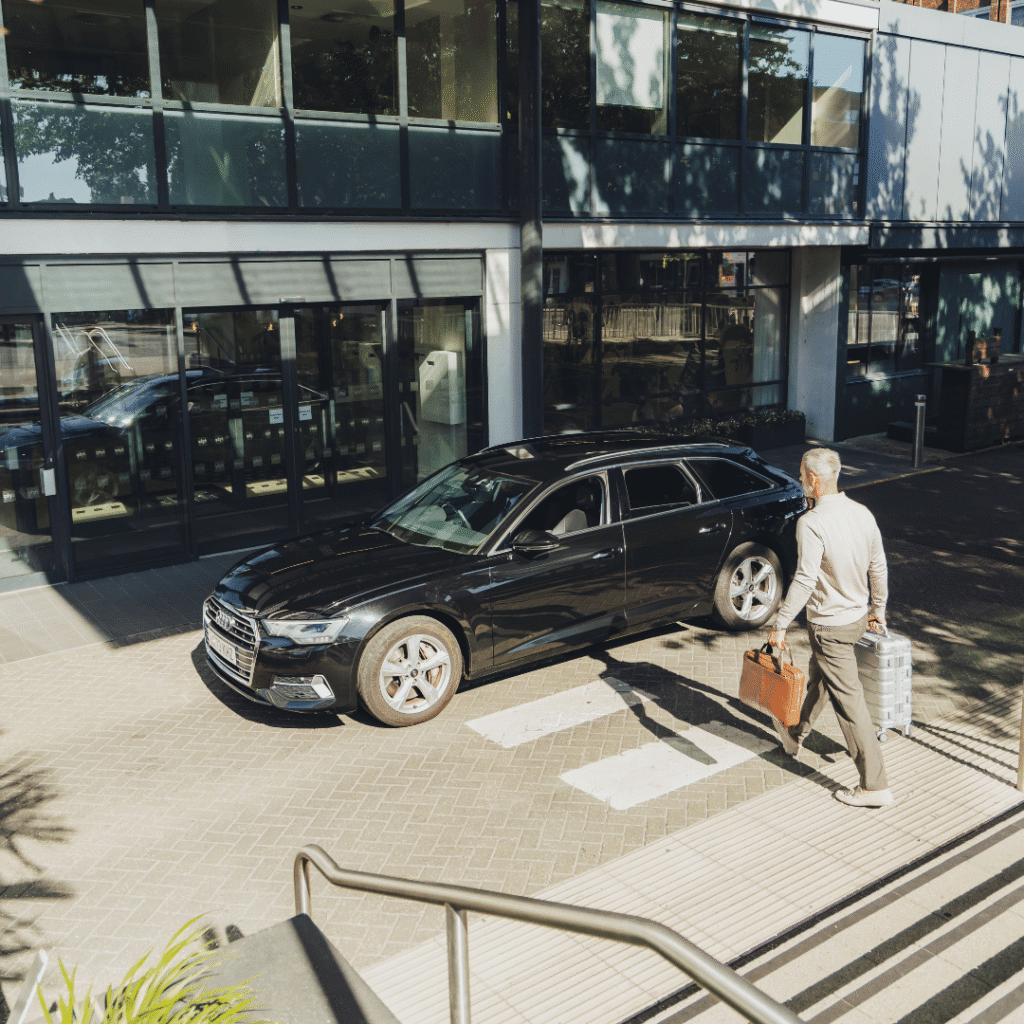 Buisnessman walking towards executive car
